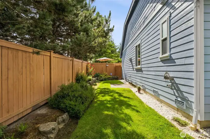 Side yard offers the exterior water spigot & allows guest the opportunity to walk to the backyard- straight to the gathering!