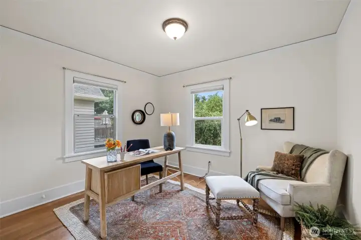 Main floor bedroom has hardwood flooring