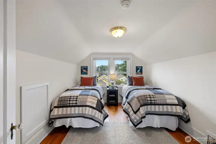 Upper floor bedroom with wood floors