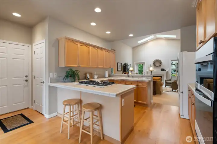 Eating bar with walk in pantry to left and large door is to the garage for easy access.