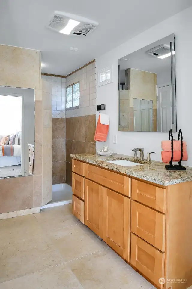 This luxurious three-quarter bath continues with custom tile, granite top vanity and large walk-in shower.