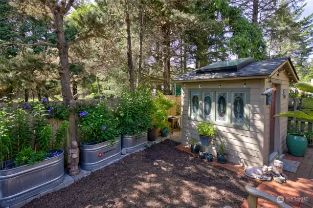 Adorable potting shed and planters abound!  This is a sanctuary for someone with a green thumb!