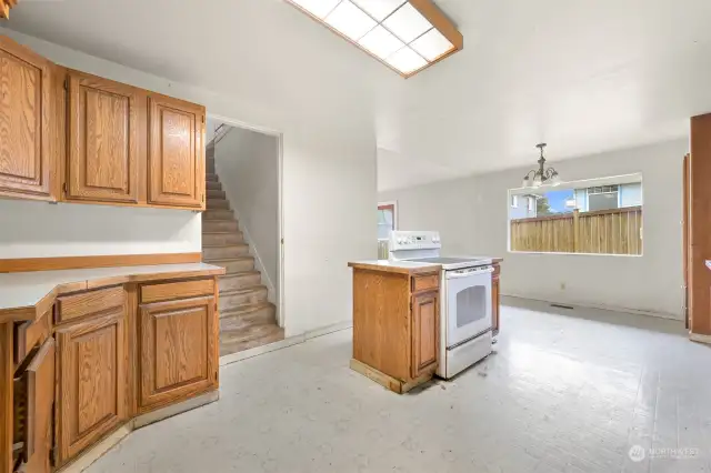 Kitchen showing stairs up to three bedrooms.