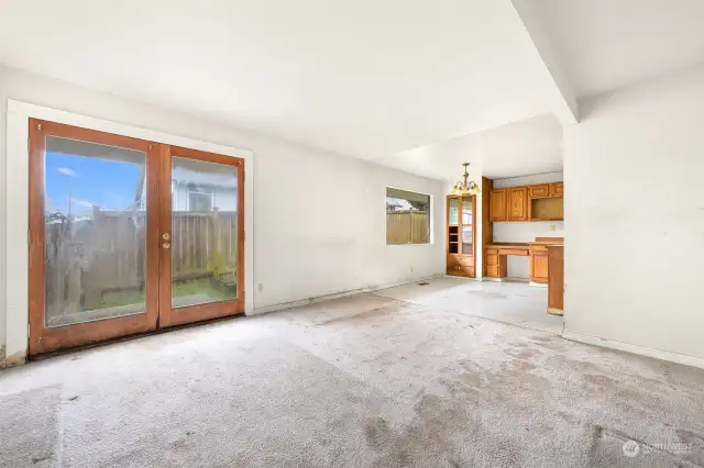 Dining area with double doors to the side yard.