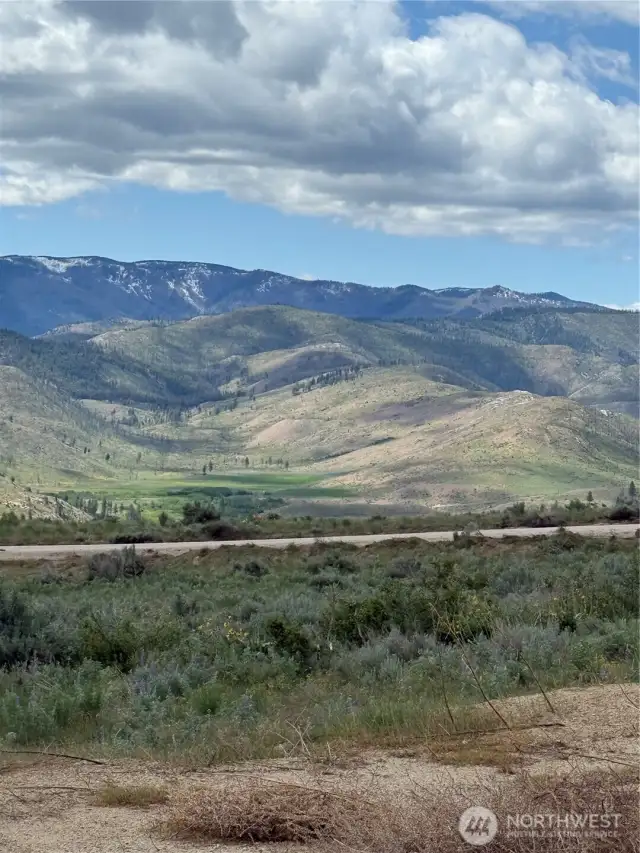Property extends beyond the road on each side of the property.