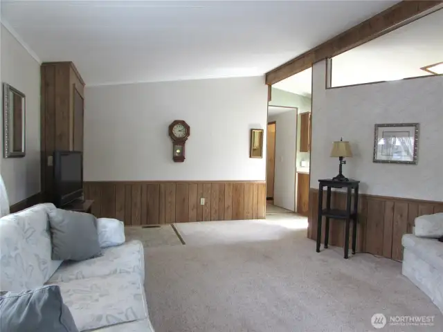 Living room w/ front door in corner.