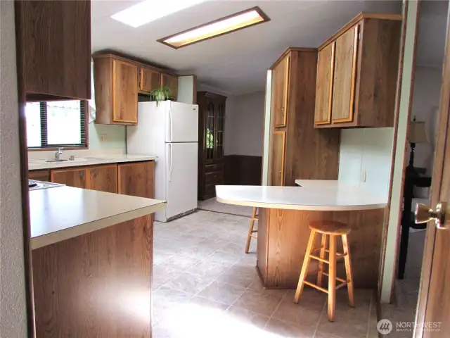 Kitchen w/ seating area and skylight.