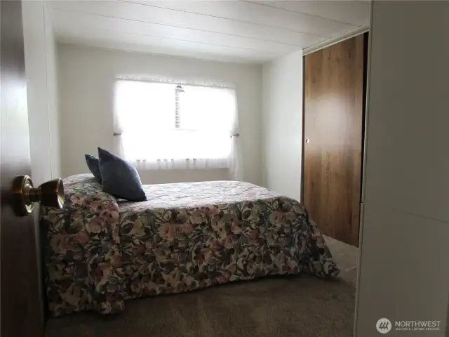 Spare Bedroom overlooks back yard garden area and open lawn area across fence.