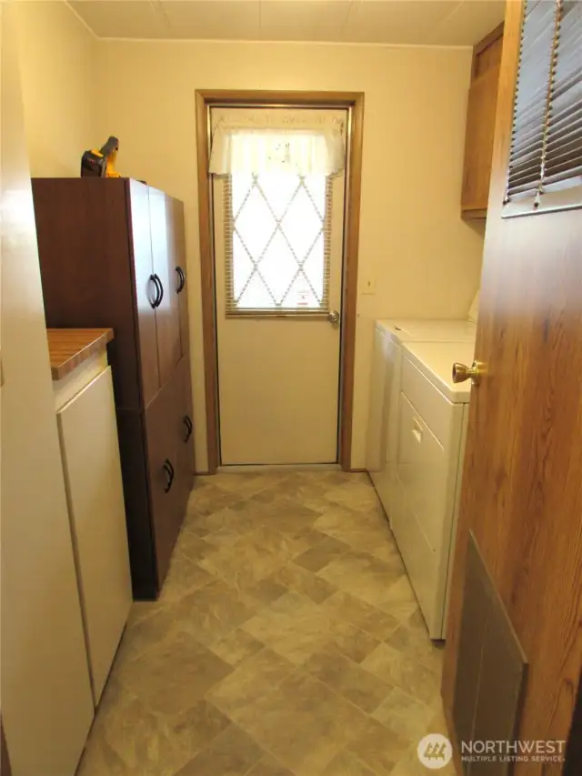 Utility room w/ back door off covered deck/Parking.