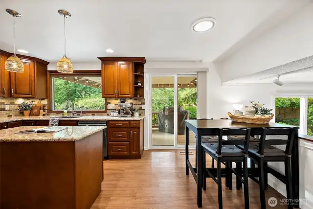 The kitchen has a glass sliding door out to the covered deck and a breakfast nook area.