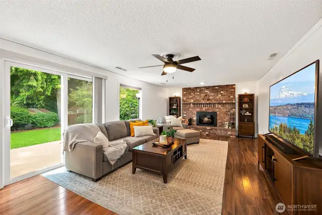 The spacious family room has a wood burning fireplace, laminate flooring, a slider to the beautiful backyard. Laundry room, powder room and garage access are adjacent.