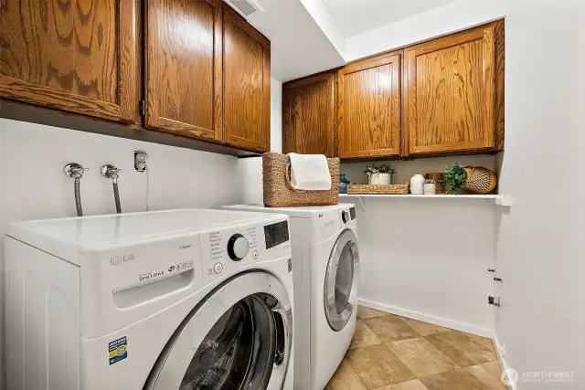 Spacious laundry room with storage cabinets.
