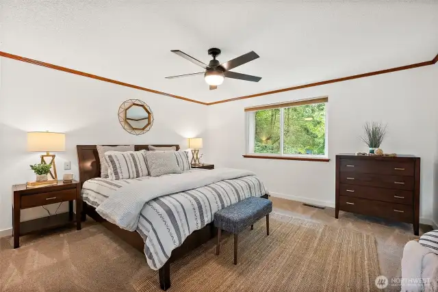 The abundant primary suite has a double door entry, large window overlooking the gorgeous backyard, an ensuite private bath and two large closets.