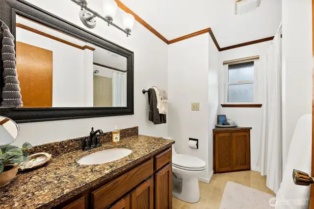 The upstairs hall bathroom also has granite counters and a tub/shower combination.