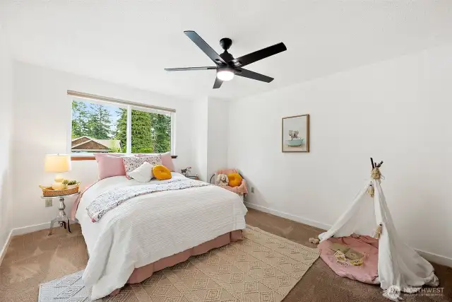 The two additional upstairs bedrooms are large and have big windows to bathe the rooms in natural light.
