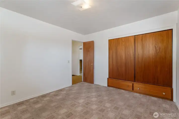 Bedroom.  Hardwood floors under carpet.