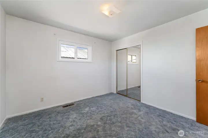 Bedroom.  Hardwood floors under carpet.