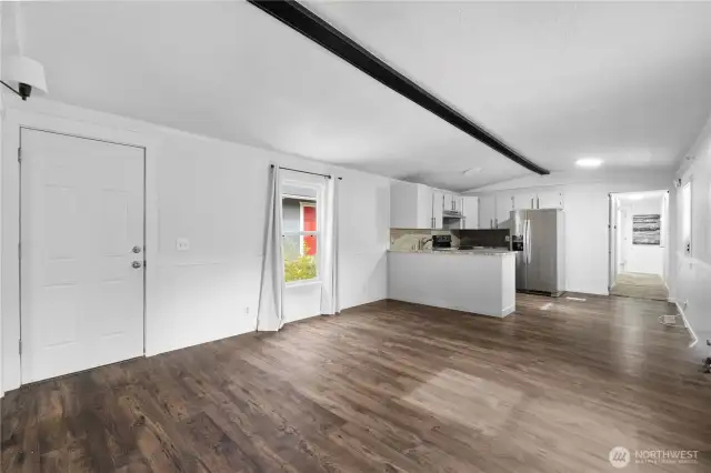 From the opposite corner you can see the kitchen and the hallway to the other two bedrooms!
