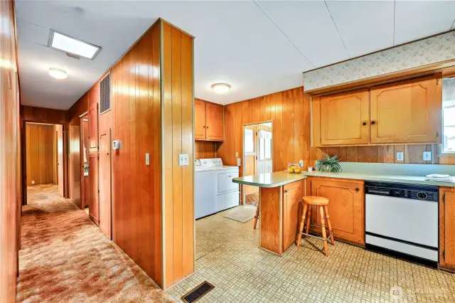 View of the counter eating space with w/d beyond. Lots of cupbord storage.