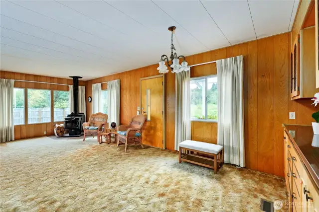 Corner wood stove. Dry wood pile on the back patio. The home also has an electric furnace/duct system.