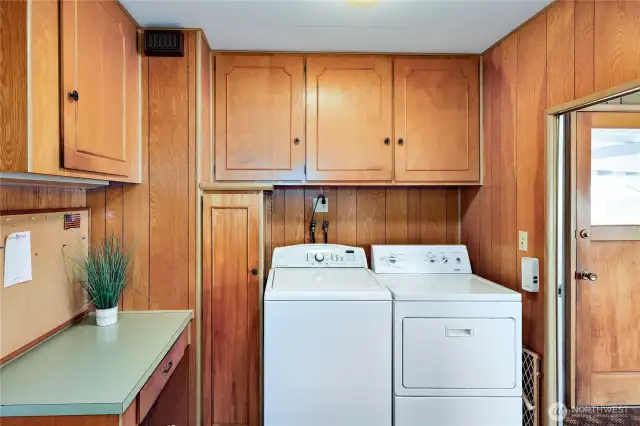 Laundry area with lots of storage, folding table and exit to the rear porch & door.