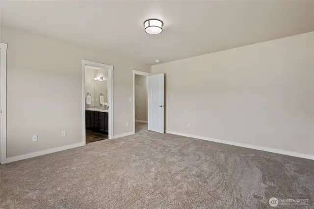 Primary bedroom showing entrance to ensuite bathroom