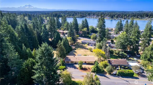 This breathtaking drone shot captures the property’s setting—just minutes from Lake Meridian with a backdrop of Mount Rainier. You get the best of both worlds: peaceful privacy among the evergreens and quick access to waterfront recreation. The neighborhood is dotted with charming homes and tree-lined streets, while the view beyond showcases why this area is so desirable. This image tells the story of location—natural beauty, community, and accessibility all in one.