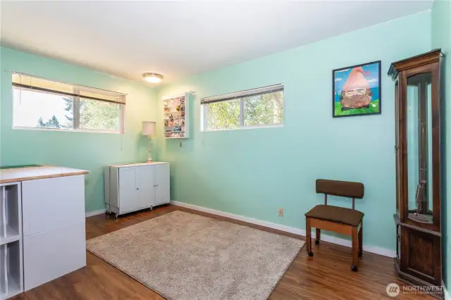 This flex space is a true bonus—perfect for hobbies, a home office, or an additional bedroom. With large windows on two walls, the room is filled with natural light, making it an inspiring spot to work or create. The calming aqua walls add a fresh, modern touch, while durable flooring keeps it practical. This is the kind of adaptable space buyers love—big enough to grow into, yet cozy enough to stay functional for daily living.
