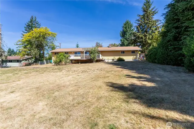 Another angle of the backyard shows off the full size of the lot. The home sits toward the front of the property, leaving this large, open space behind. The fenced perimeter offers peace of mind for pets or kids, while the flat terrain makes it easy to use every square foot.
