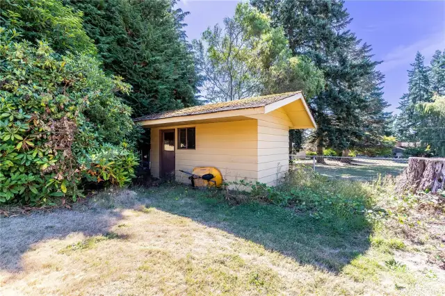 A detached shed sits tucked into the corner of the property, offering excellent storage for tools, equipment, or hobby projects. Its convenient placement keeps the main yard open while providing plenty of utility. For gardeners or DIY enthusiasts, this is a valuable addition that adds both function and flexibility to the property.
