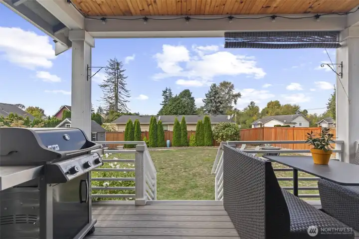Back porch leading to the fully fenced backyard