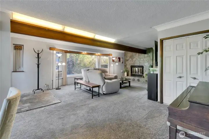 Another view of the living room showcasing large windows and natural light.