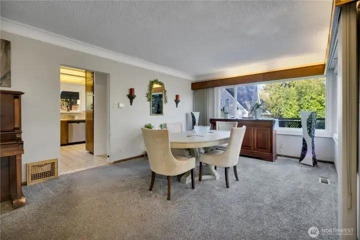 Dining room (possibly original hardwood flooring under carpet).