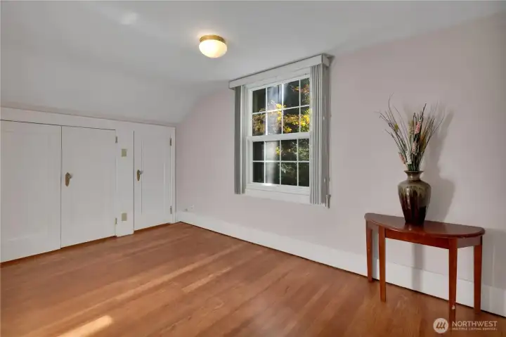 Bedroom at end of hall w/window overlooking side yard.
