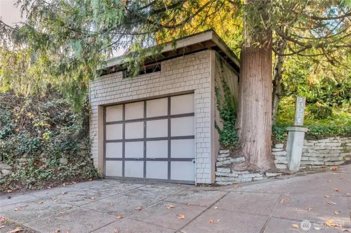 Detached garage with additional parking at the bottom of the driveway.