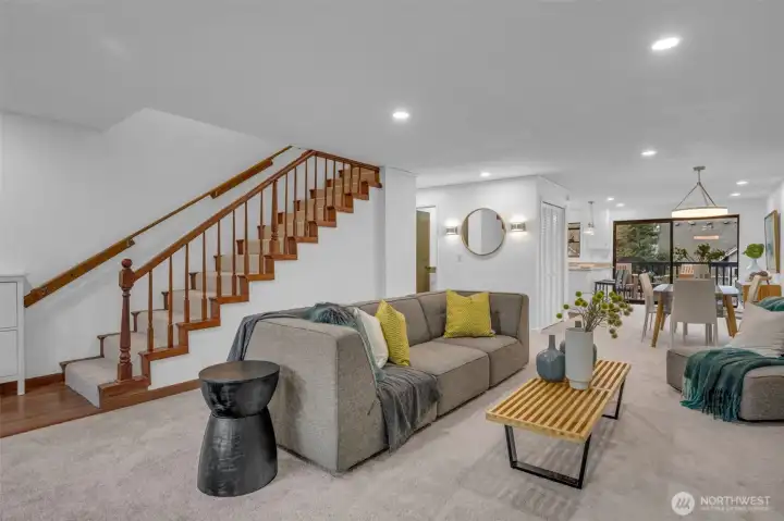 Grand staircase leads you to the upper 2 bedrooms. The living room and dining room flow seamlessly with each other right in to the beautfil kitchen with breakfast bar.  New can lighting, wall sconces and overhead dining room lighting.