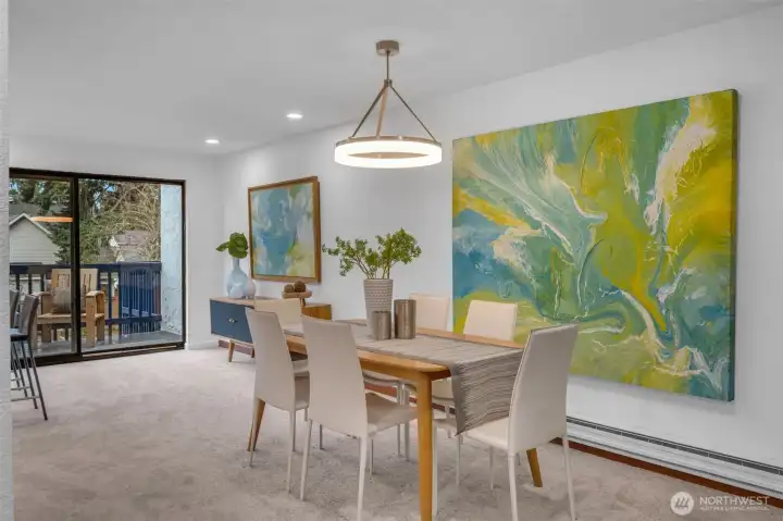 Dining space is centralized to the kitchen and living room.  Contemporary lighting makes the space feel warm and inviting.  You'll feel excited to entertain in this space with room for all.
