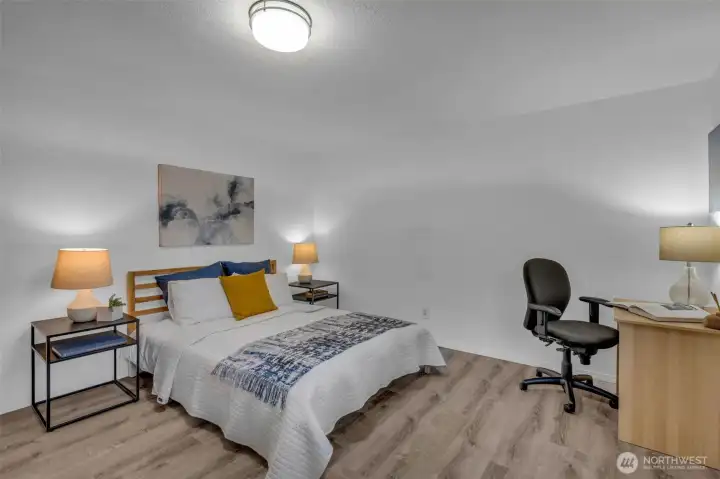 Secondary bedroom on the upper level has tons of space.  Luxury vinyl plank flooring with new lighting and baseboard trim.