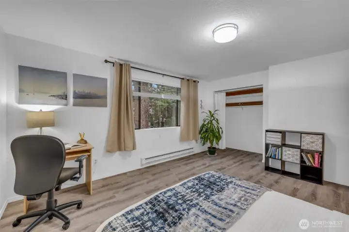 Secondary bedroom on the upper level has tons of space.  Space for a desk or sitting area with double closet.  Luxury vinyl plank flooring with new lighting and baseboard trim.