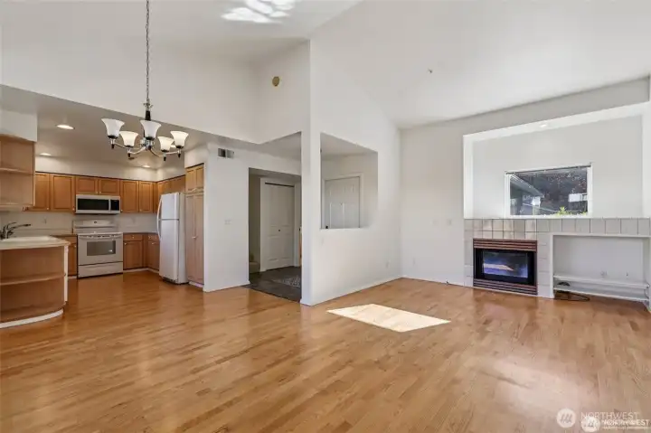 A cozy gas fireplace and vaulted ceilings - gleaming hard wood floors