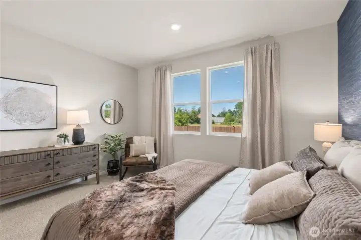 Enjoy natural morning light through the primary bedrooms large windows. Actual home is under construction. Colors, materials, and features may vary. See site agent for details.
