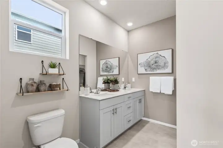 Primary bathroom with modern design. Actual home is under construction. Colors, materials, and features may vary. See site agent for details.