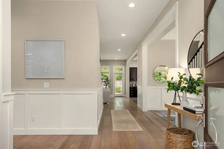 Light-filled entry with wide-plank hardwood floors, designer wainscoting, and an open-concept layout that flows seamlessly into the main living spaces. Welcome home to modern Bainbridge Island living at its best.