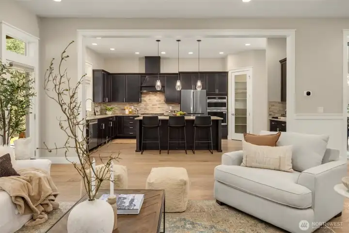 Open-concept living room with wide-plank hardwood floors, modern gas fireplace, and clean architectural lines—designed for comfortable everyday living and effortless entertaining.