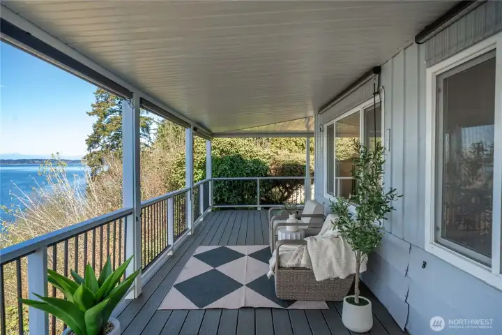 The covered wraparound deck invites year-round enjoyment, where fresh coastal air and water views create a peaceful retreat.