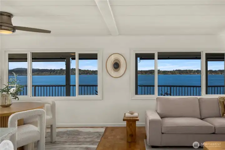 Expansive windows bring the outdoors in, filling the living area with natural light and stunning water views.