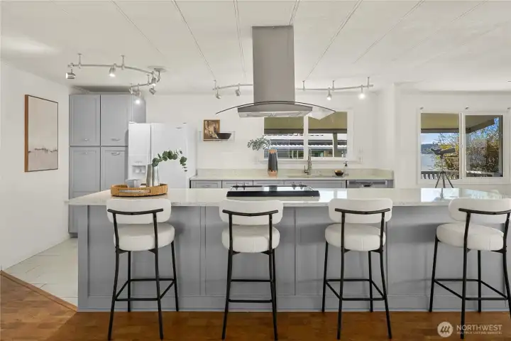 Clean lines and thoughtful design shine through with granite countertops and new cabinetry, creating a bright, functional kitchen centered around connection and conversation.