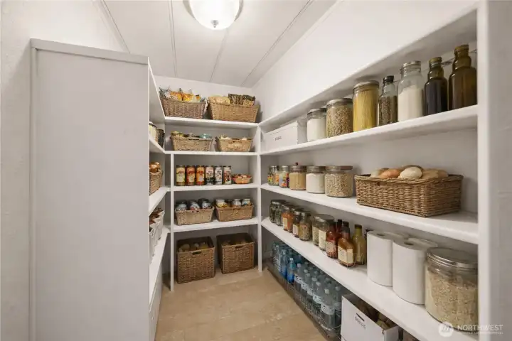 A spacious walk-in pantry keeps everything organized and within reach, blending convenience with clean, functional design.           (photo virtually staged)