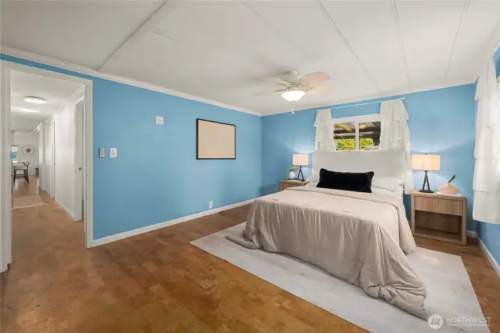 The primary suite offers a peaceful retreat with its own private entrance, generous space, and a calming coastal-inspired palette.