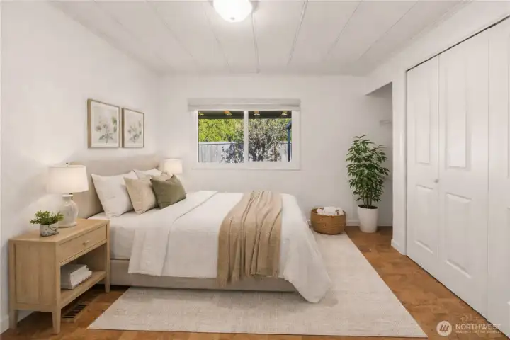 A bright and inviting bedroom offers comfort and versatility, complete with a large closet and built-in shelving for added storage and convenience.      (photo virtually staged)